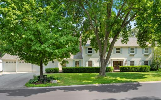 The front of this classic two-story Colonial, located in the heart of the prestigious Parkwood Knolls neighborhood of Edina, showcases timeless elegance.