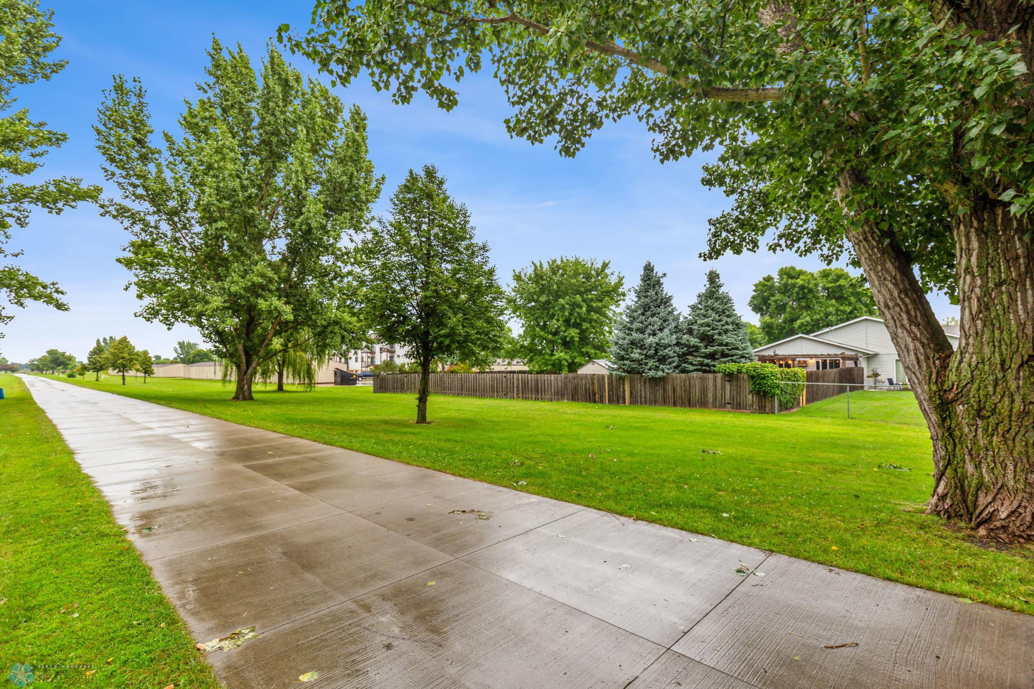 green space/walking path behind the fence