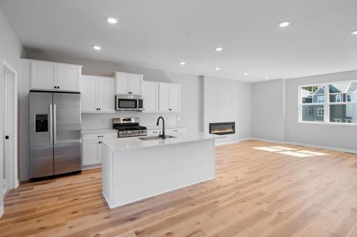 View of the kitchen and family room. 9 foot ceilings, tall windows and extra lighting!