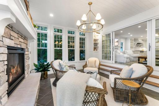 A view from the sunroom into the family room and kitchen