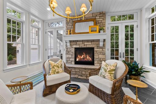 The sunroom has heated floors and a gas fireplace