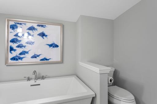 The shared bath also has double sinks and a separate tub and shower