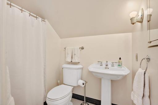 3rd floor 3/4 bath with a black & white tile floor