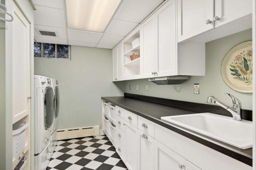 Fully finished bright laundry room with custom built-in cabinets