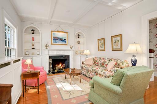 Living room with spectacular fireplace flanked by arched built-ins plus a coffered ceiling.