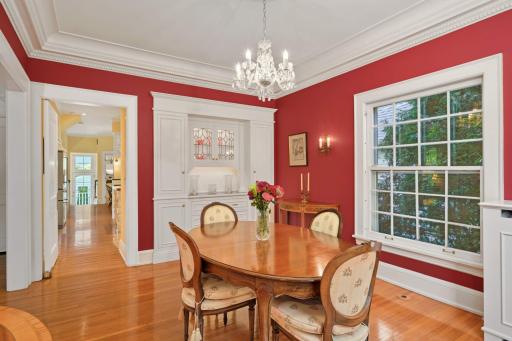 A custom built-in buffet with carved pilasters, a marble serving space, leaded-glass windows