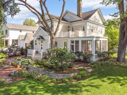A huge backyard with extensive landscaping by Bachmanâs, including a low-maintenance perennial garden. A charming white picket fence is shaded by giant trees