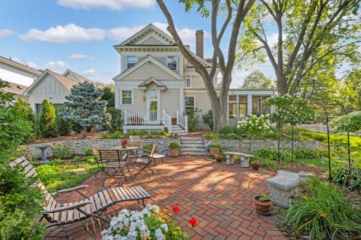 A huge back and side yard with herringbone paver patio and low maintenance perennial gardens