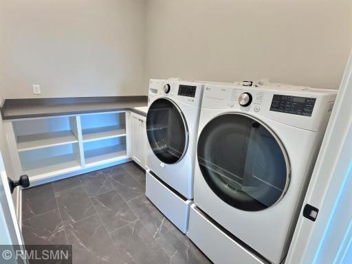 Stay organized with the main level laundry room offering a sink/cabinet, built in folding table and spacious shelves for baskets.