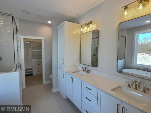 Imagine a primary suite bathroom with double sinks (rectangle bowls), custom cabinets and tile flooring...you will absolutely fall in love!