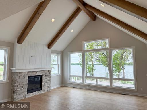 Soaring 9 foot vaulted ceilings showcase the lake, imagine days spent warmed by the gas fireplace while taking in Views of Lake John.