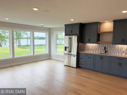 The lower level will be the place to entertain this summer, complete with a fantastic wet bar with custom touches.