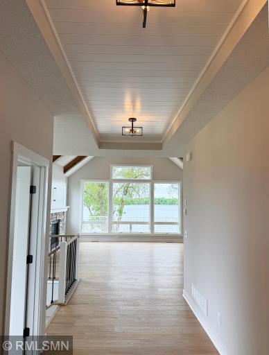 Lake John welcomes you from the foyer leading into the home with shiplap accent ceiling and unique light fixtures.