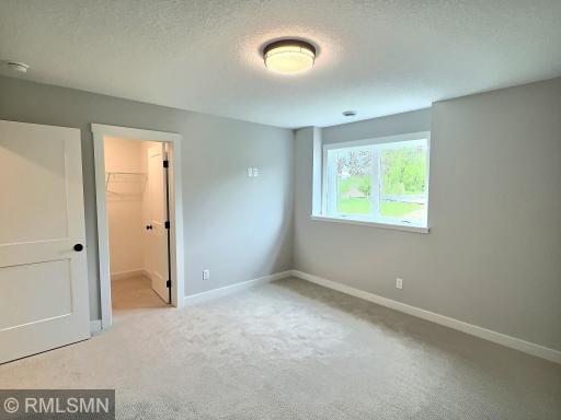 The spacious fourth bedroom is also in the lower level with a three-quarter bathroom just steps away.