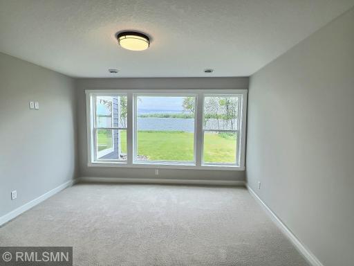 Turn-in for the night in the third bedroom located in the lower level offering amazing Lake John views.