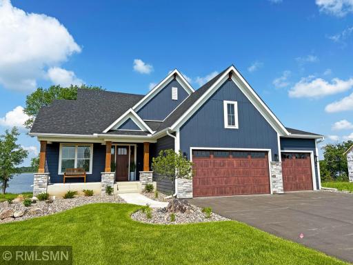 A covered entry with pine shiplap accent welcomes you home and leads to a spacious main level with gathering in mind.
