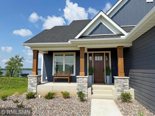 What a fantastic walkway leading to the front porch lined with perennials and rock landscaping.