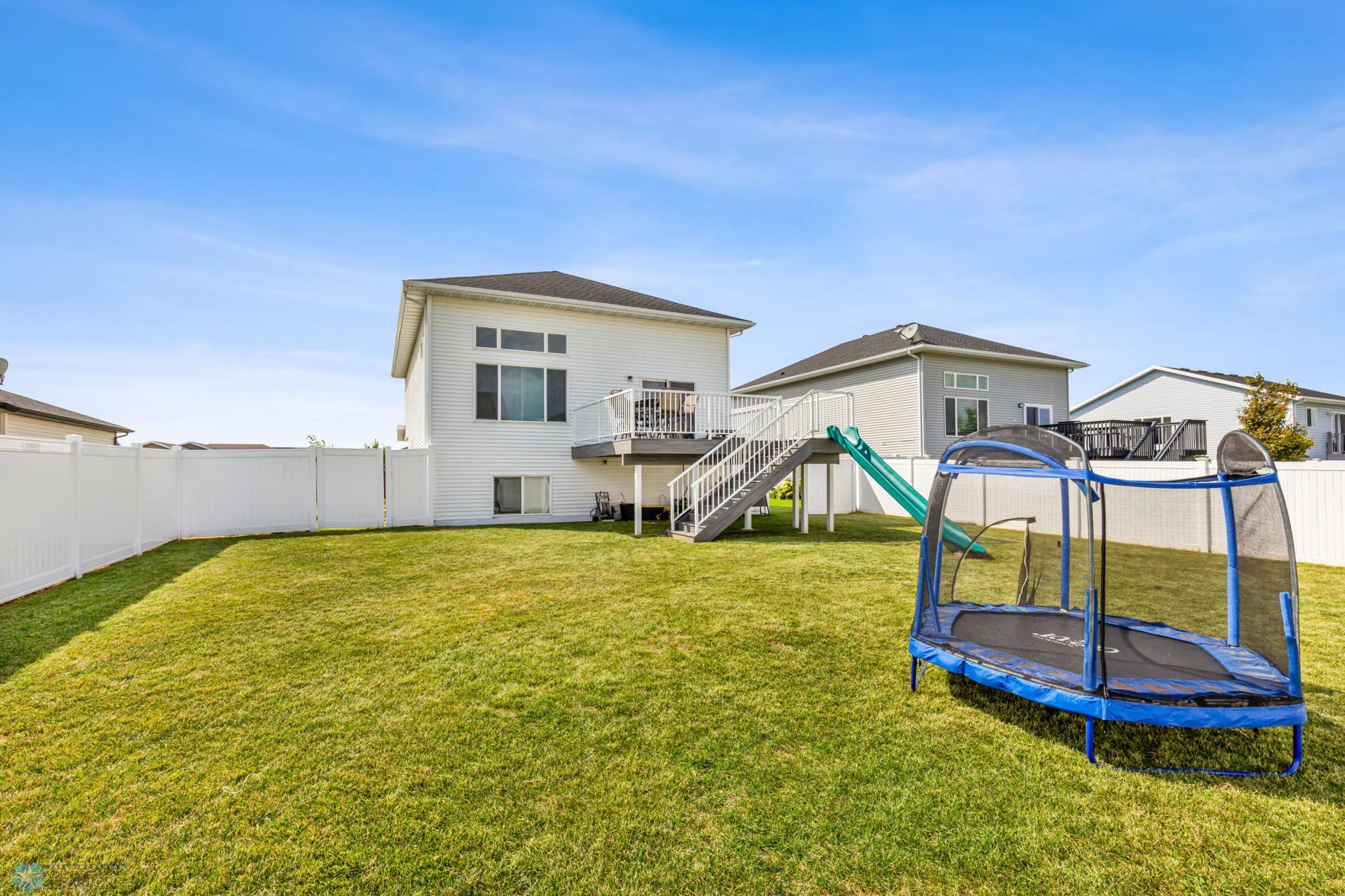 Fenced Back Yard With Deck