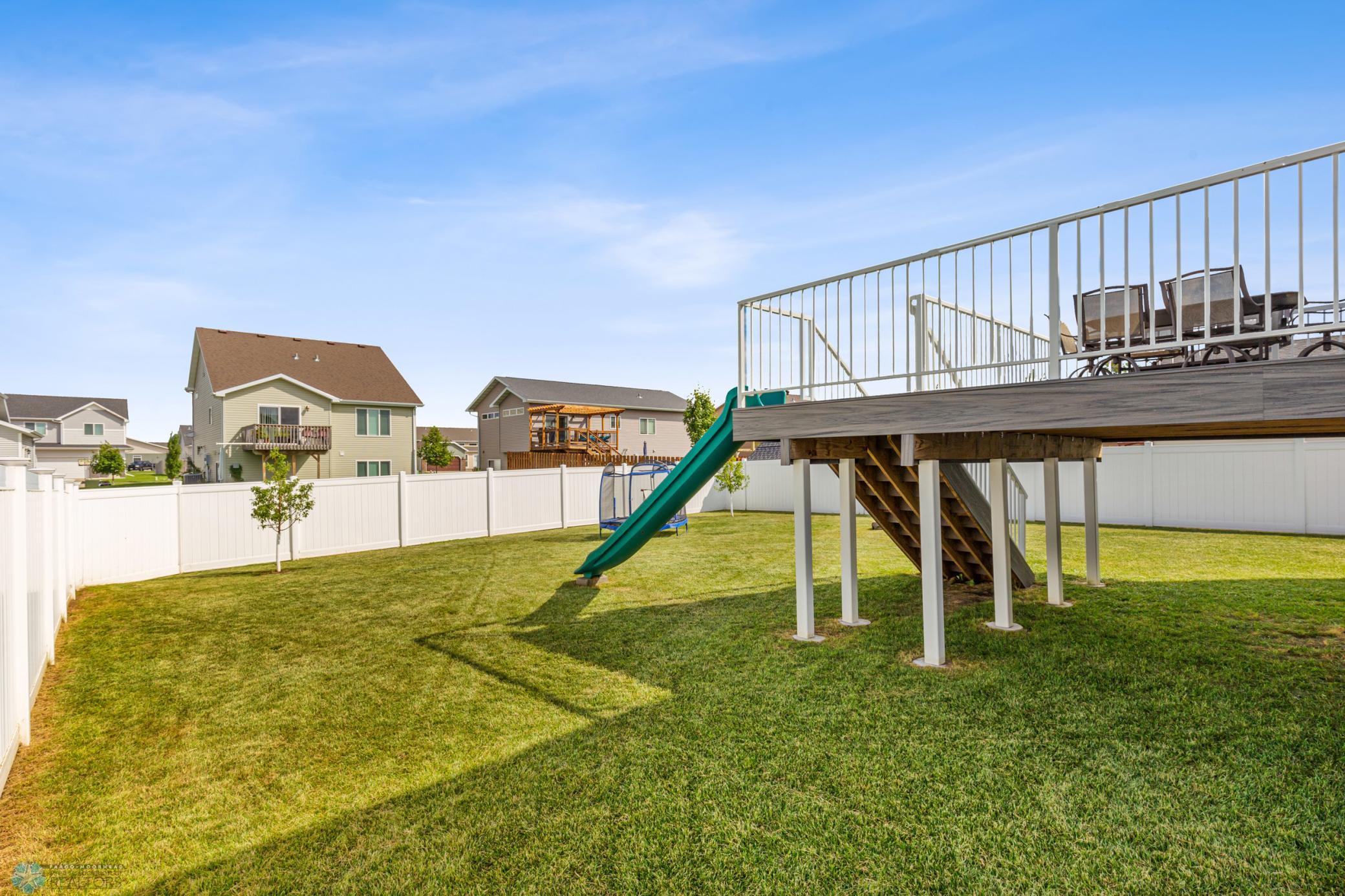 Fenced Back Yard With Deck