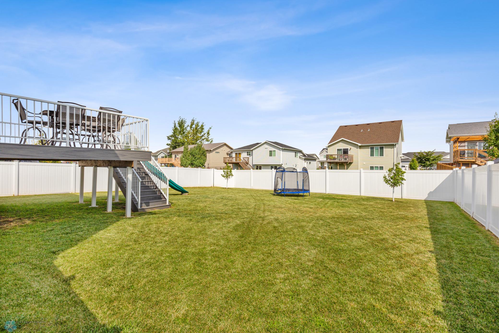 Fenced Back Yard With Deck
