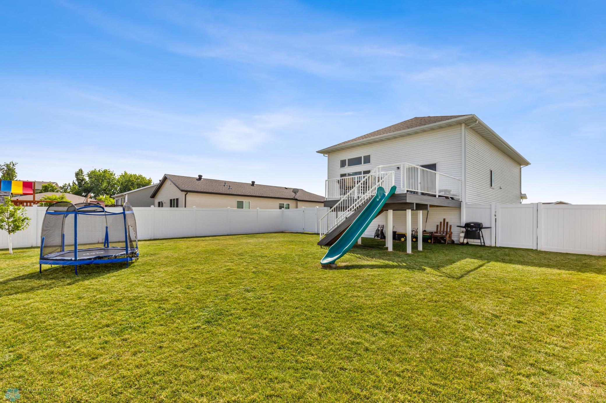 Fenced Back Yard With Deck