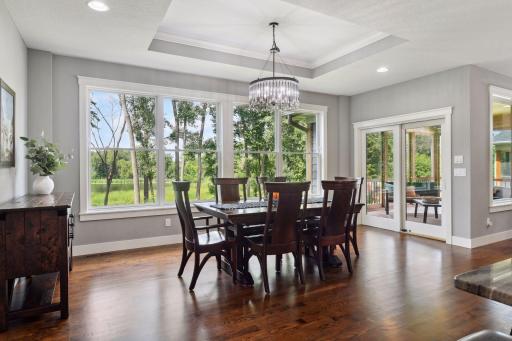The informal dining area, which also seats ten, leads to a screened porch ideal for morning coffee or evening relaxation.