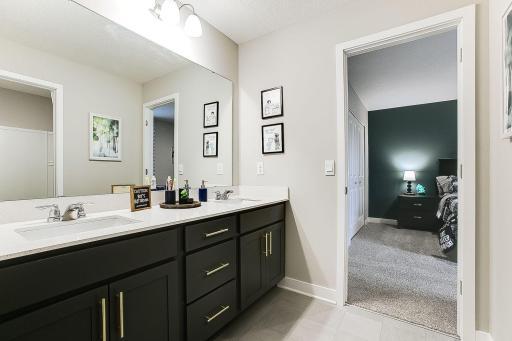 2 of the secondary bedrooms are connected by a highly sought after Jack and Jill bath. This space includes dual vanity sinks as well as a private tub/shower area. **PHOTO OF MODEL SELECTIONS AND COLORS WILL VARY!