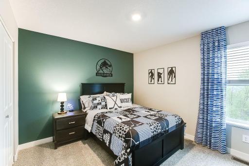 Secondary bedroom with private Jack and Jill bath access. **PHOTO OF MODEL SELECTIONS AND COLORS WILL VARY!