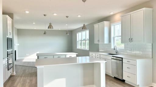 Subject home has white cabinets and white quartz counters. Photo of model home, colors and finishes may vary.