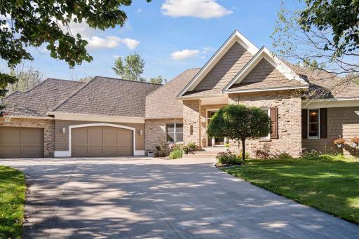 Attractive curb appeal with a mix of brick and James Hardie siding plus a concrete driveway.