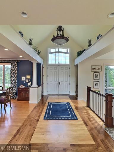 Brazilian Walnut accents to the Maple floors are one of the many details in this spacious foyer. Very inviting as you walk in, with gorgeous attention to detail.
