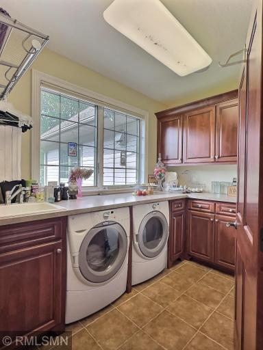 Laundry room is on the main level, with great counter space for sorting and folding clothes, along with extra cabinets for storage.