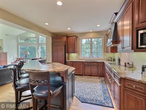 Granite countertops throughout, custom cabinetry fills this kitchen, including the pantry with full extension shelves.