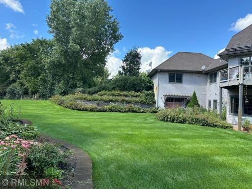 Beautiful landscaping showcases gardens throughout, complete with