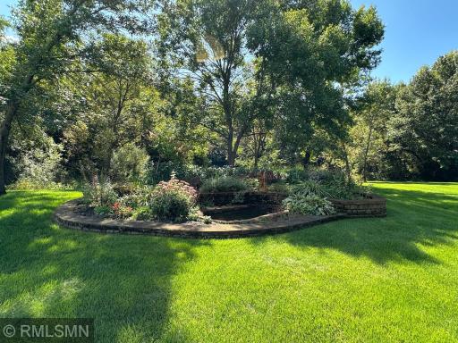 The yard as you walk out lower level is secluded and very private. Irrigation covers grass, gardens, and landscaping.
