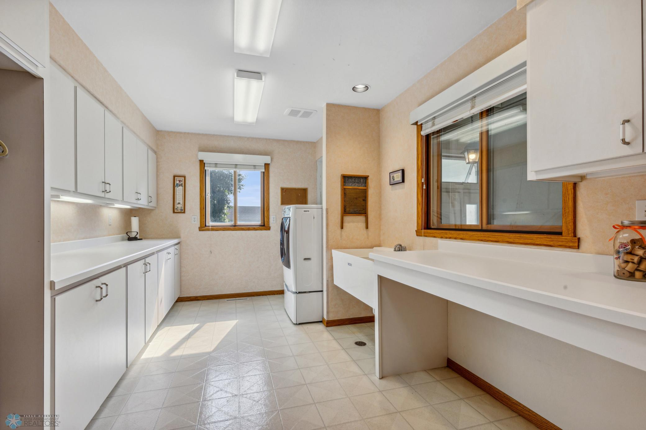 Large Laundry Room w/ Laundry Sink, Cabinetry & ample counter space