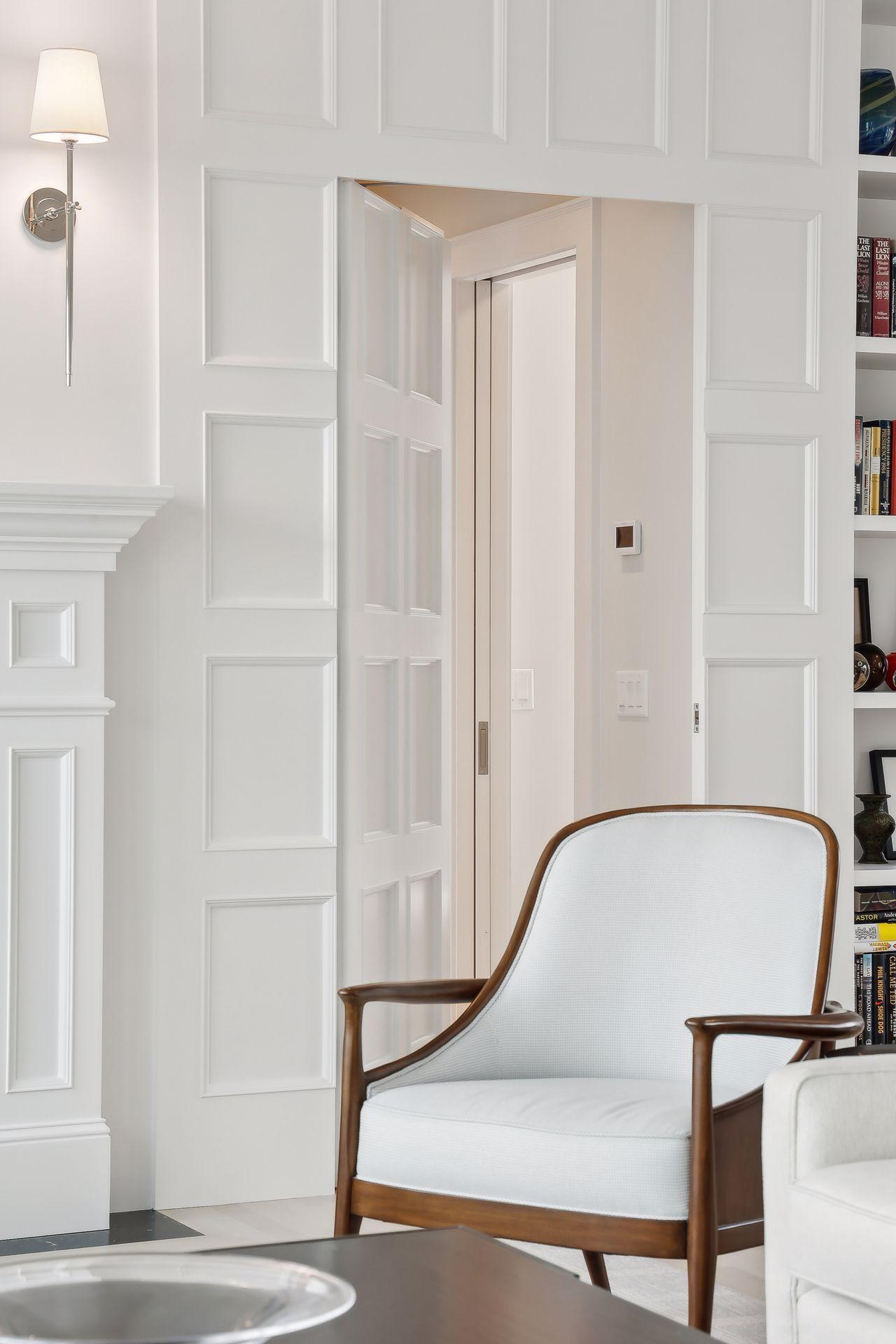 The panel next to the book shelves pushes open to private access to the primary suite.