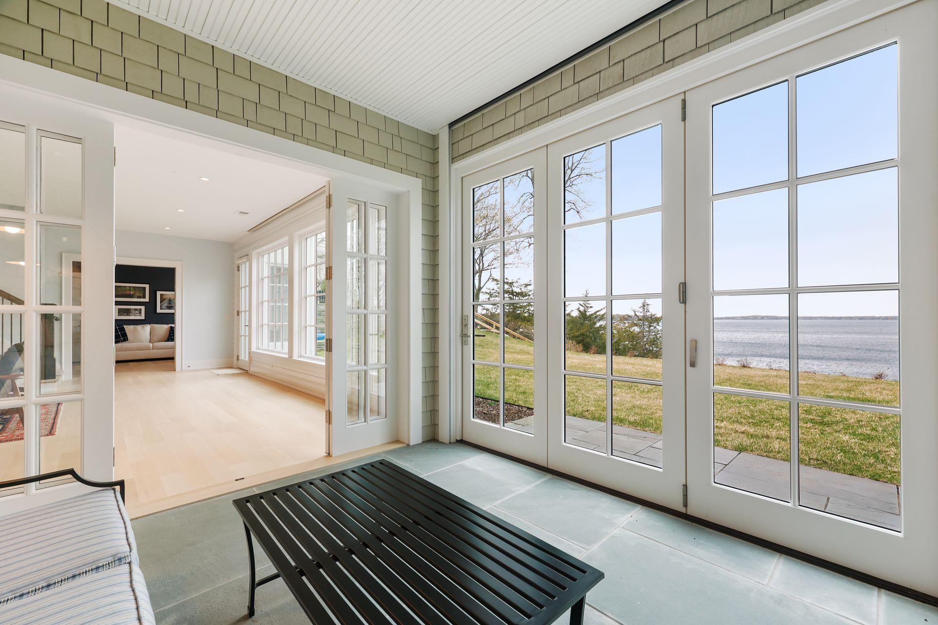 Porch has sliders, including phantom screens, that open completely to the outside.