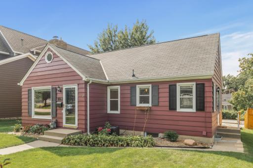 This charming 1.5-story home in the heart of Edina, boasts incredible curb appeal with a picturesque exterior, lush greenery, and a welcoming front entry.