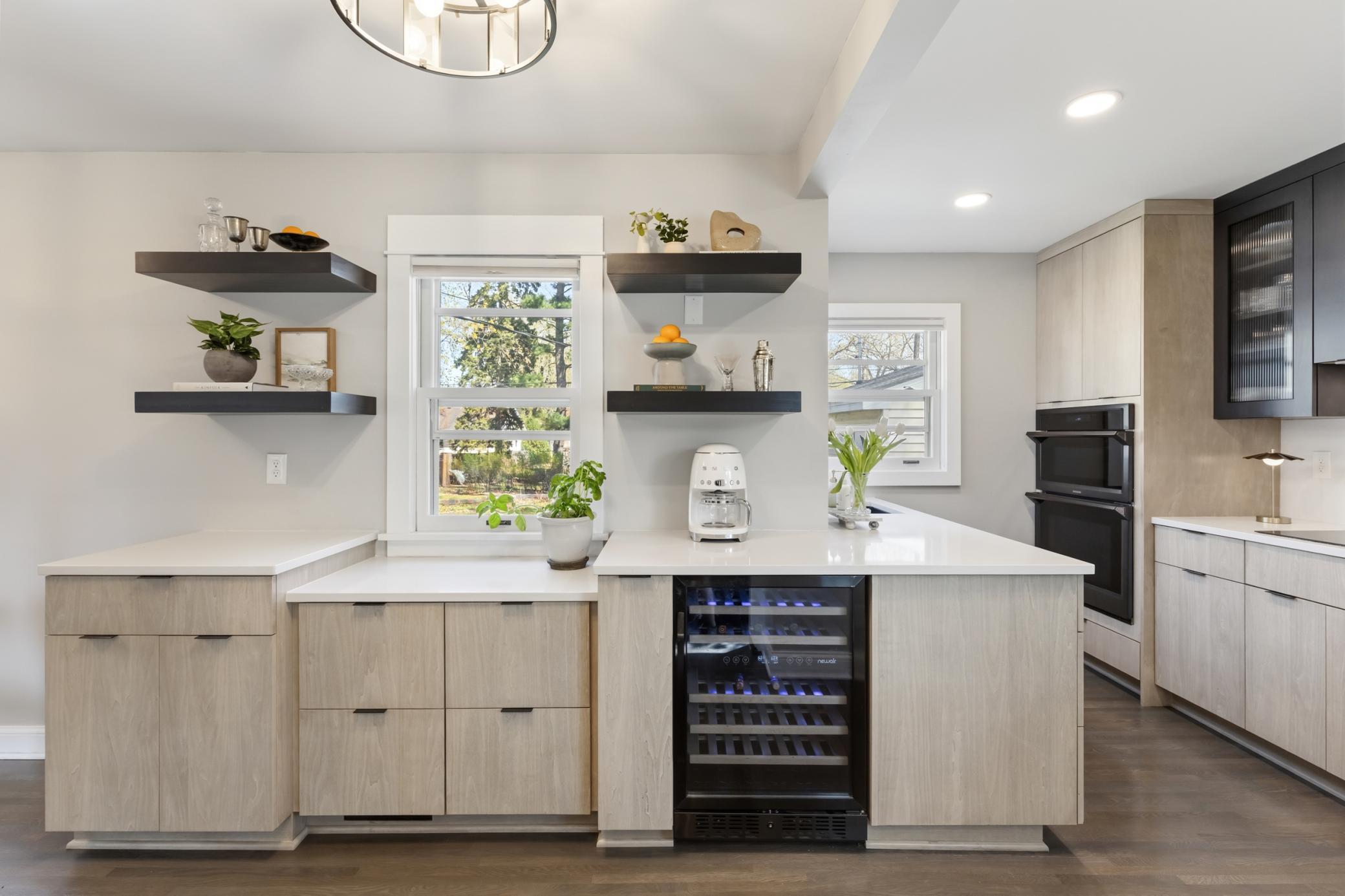 So many amazing features in this kitchen from floating shelves to convenient drawer cabinets.
