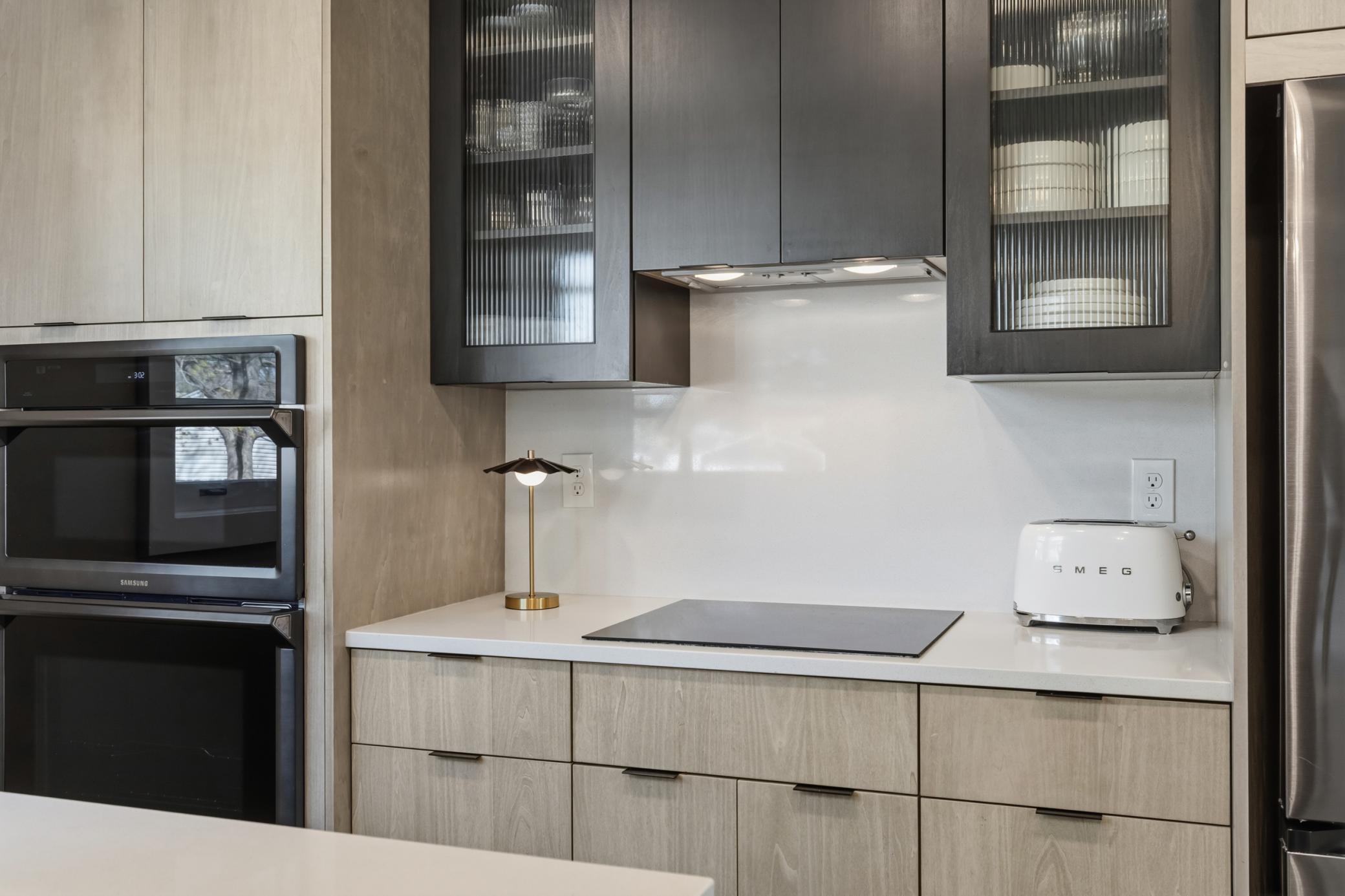 Sensational glass front cabinets and a sleek vent hood over the cooktop.