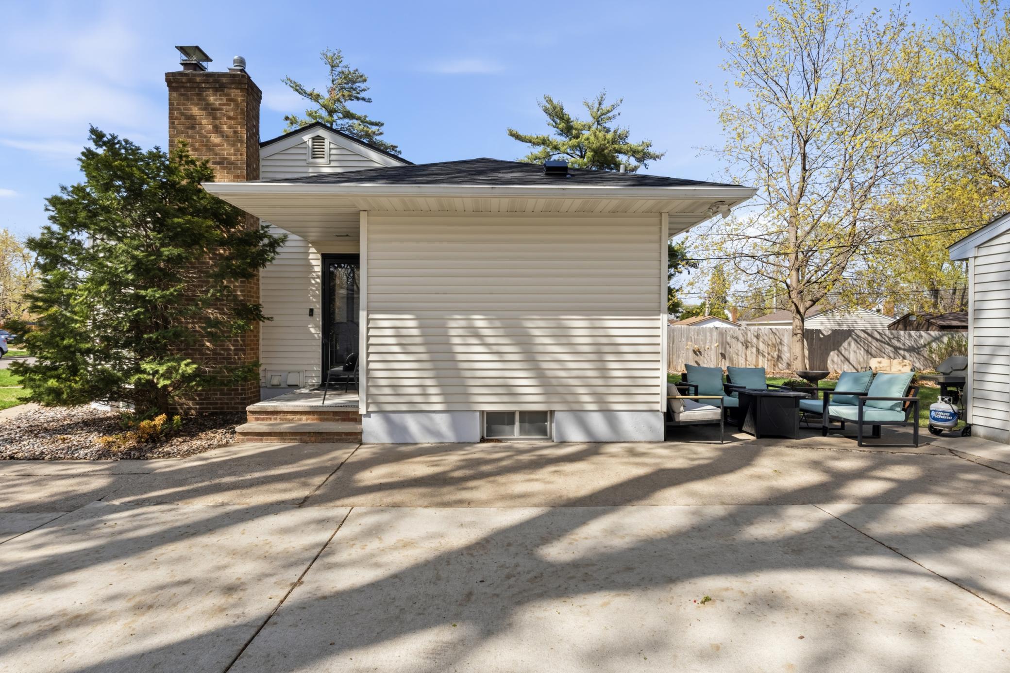 Side entry and expansive patio/driveway