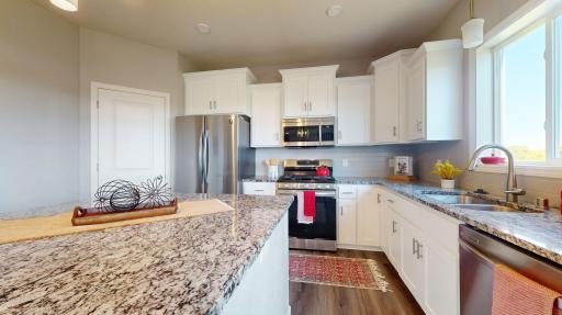 Equipped with newer stainless steel appliances, this modern kitchen is ready for both everyday meals and entertaining