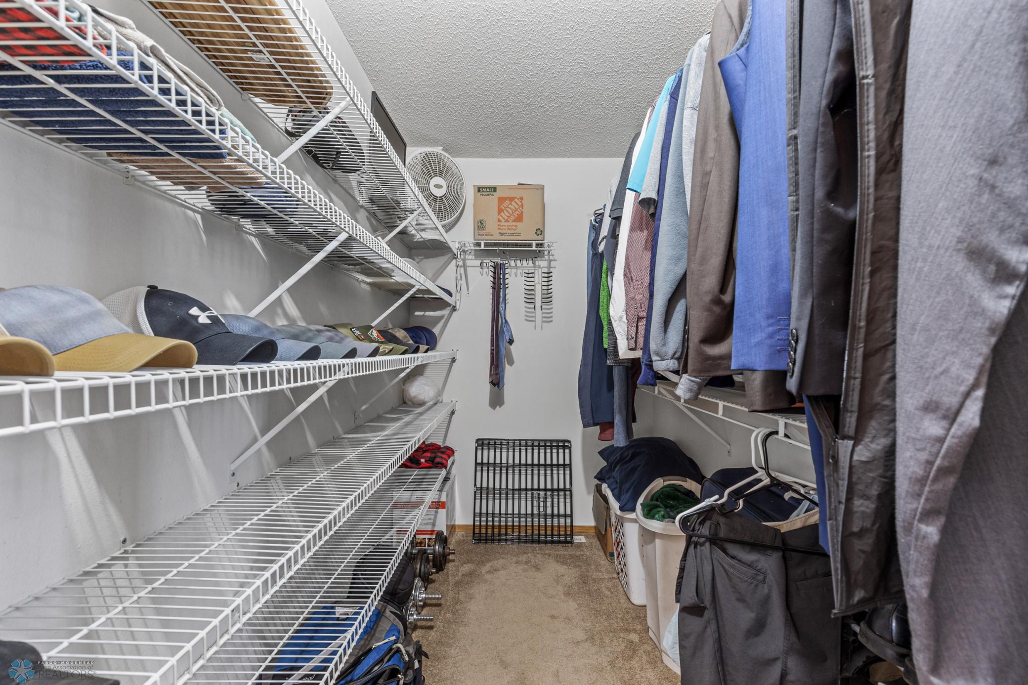 Primary bedroom walk-in closet