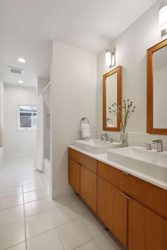 An upper level full bath with double vanity and medicine cabinets serves the 2nd and 3rd bedrooms.