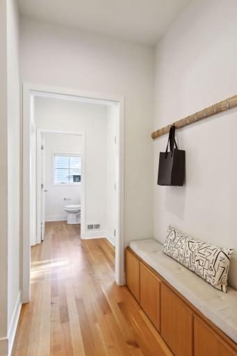 Main level mudroom adjacent to the patio entrance with a discreet powder room down the hall. Main level office is just to the left and opposite the patio entrance.