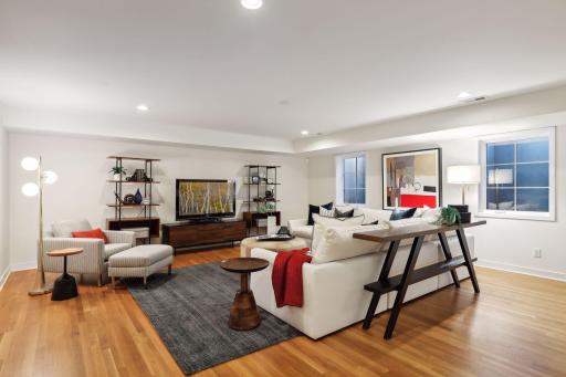 Large lower level family room with deep window wells and wonderful natural light. 8' foot ceilings and hardwood floors throughout finished lower level.