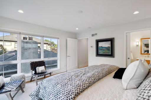 The primary bedroom features an enormous walk-in closet and private en suite bath with walk-in shower and double vanity.