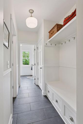 Mudroom with tile floor and custom storage bench