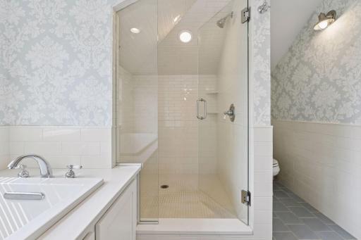 Spacious primary ensuite bathroom with large tiled walk in shower